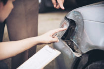 Insurance Agent Working On Car